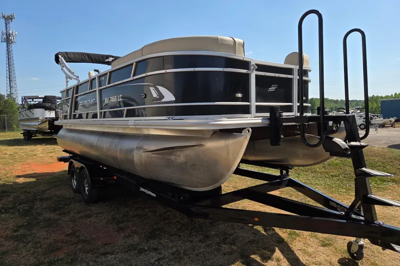Slide: The Image of 2019 Starcraft EX 20 CF pontoon boat on trailer, parked outdoors. - 2