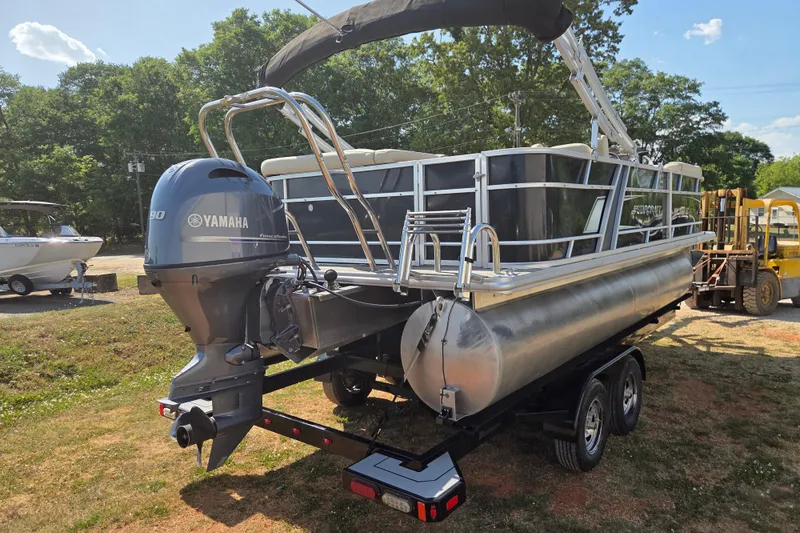 Slide: The Image of 2019 Starcraft EX 20 CF pontoon boat with Yamaha outboard motor on trailer. - 4