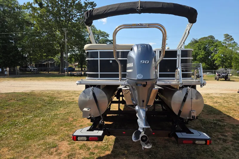 Slide: The Image of 2019 Starcraft EX 20 CF pontoon boat with Yamaha 90 engine, parked on grass. - 5