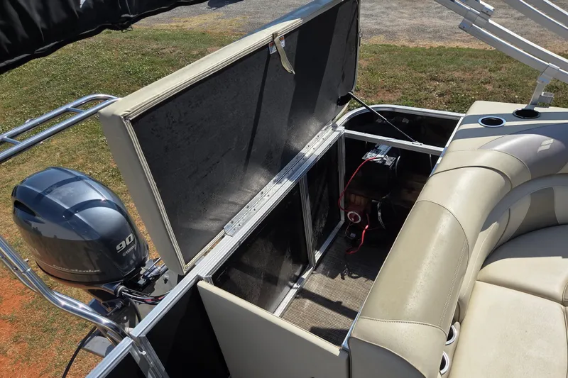 Slide: The Image of 2019 Starcraft EX 20 CF boat interior with open storage compartment and Yamaha 90 engine. - 9