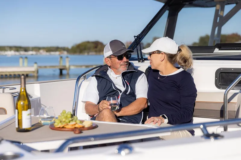 Slide: The Image of Manufacturer Provided Image: Couple enjoying wine and snacks on a 2025 Solara S-310 CW boat. - 14