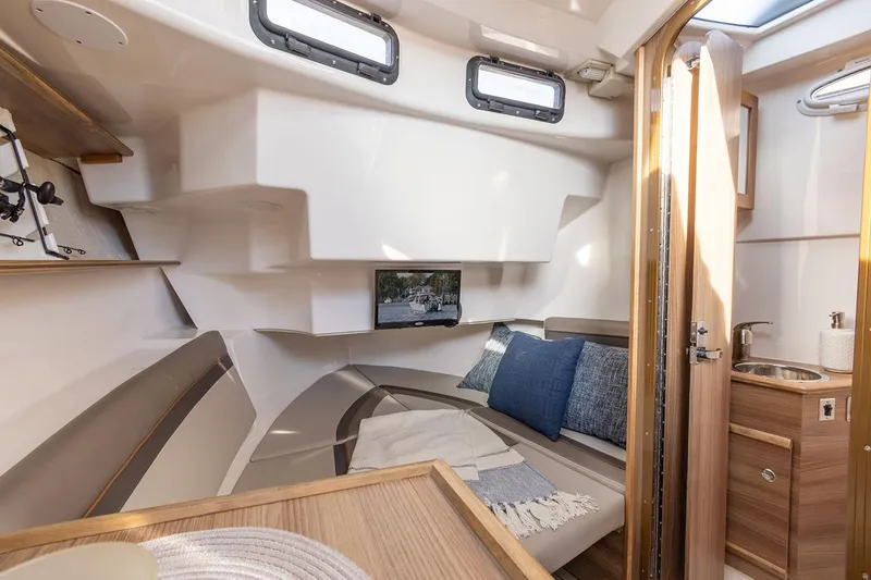 Slide: The Image of Manufacturer Provided Image: Interior of 2025 Solara S-310 CW boat, featuring cozy seating and modern amenities. - 25