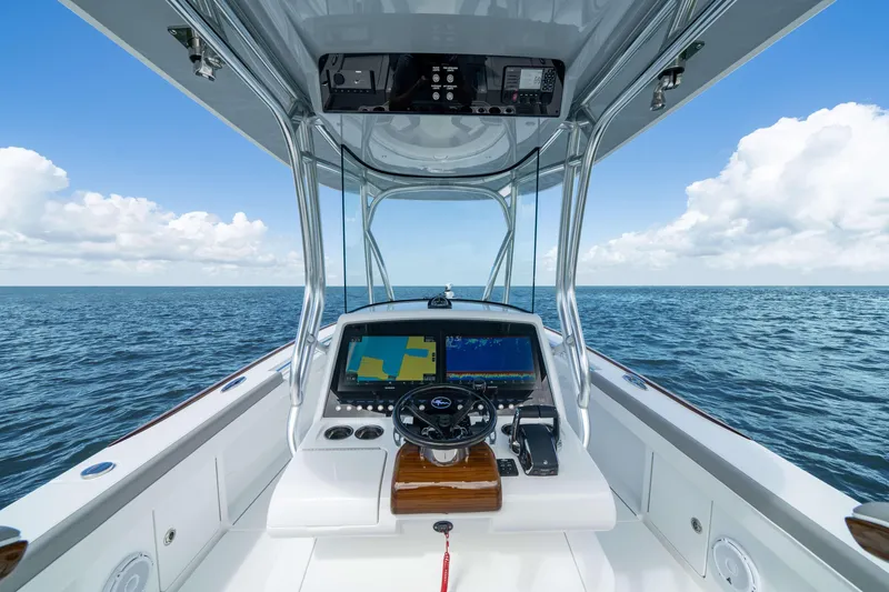 Slide: The Image of 2026 Valhalla Boatworks V-29 Hybrid helm with ocean view, featuring advanced navigation displays. - 3