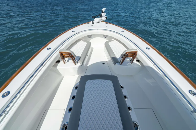 Slide: The Image of 2026 Valhalla Boatworks V-29 Hybrid bow with seating, on calm blue water. - 5