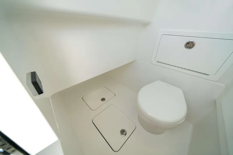 Slide: The Image of 2026 Valhalla Boatworks V-29 Hybrid interior bathroom with modern white fixtures. - 9