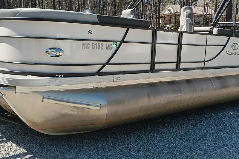 Slide: The Image of 2023 Veranda Relax VR22RC pontoon boat side view outdoors. - 2