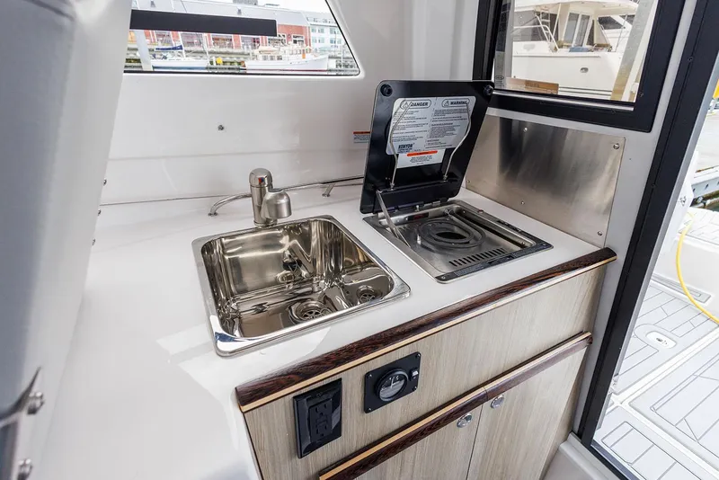 Slide: The Image of Manufacturer Provided Image: Compact kitchenette in 2025 Solara S-250 Coupe with sink and stove. - 15