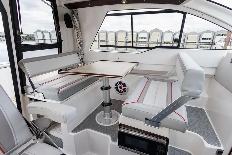 Slide: The Image of Manufacturer Provided Image: Interior of 2025 Solara S-250 Coupe with modern seating and table setup. - 7