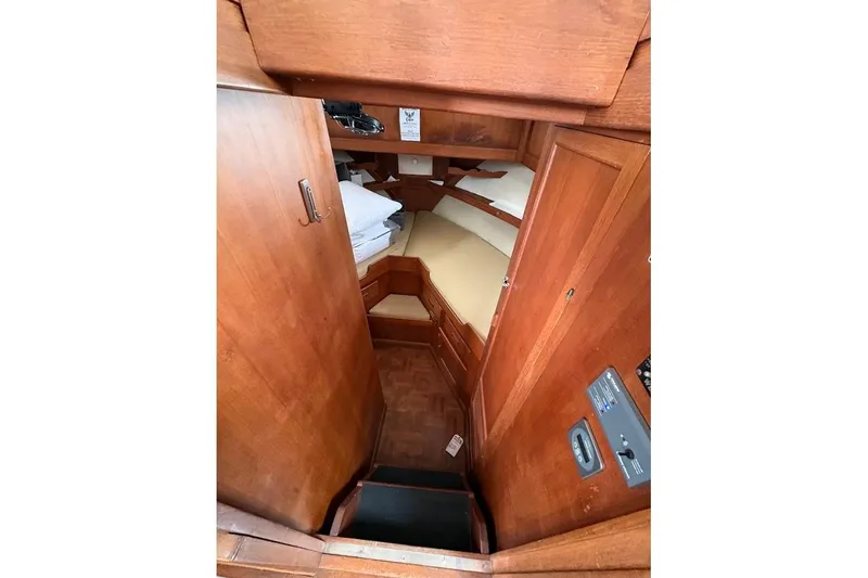 Slide: The Image of Interior cabin view of 1987 Albin 36 Trawler with wooden finish and cozy sleeping area. - 10