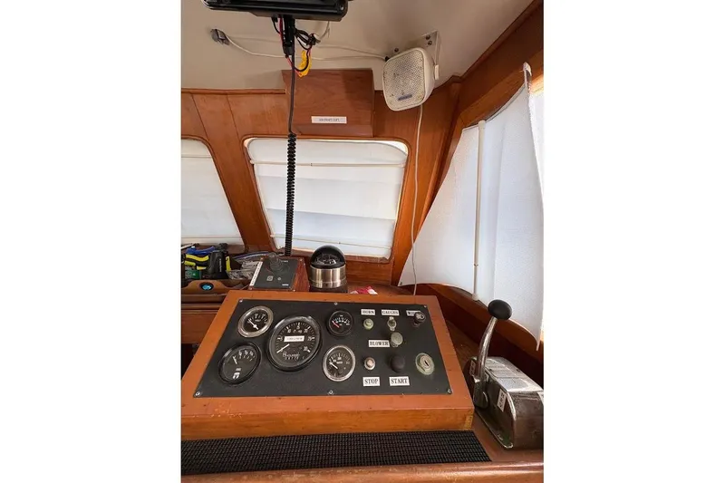 Slide: The Image of 1987 Albin 36 Trawler helm with gauges, controls, and wooden interior. - 12