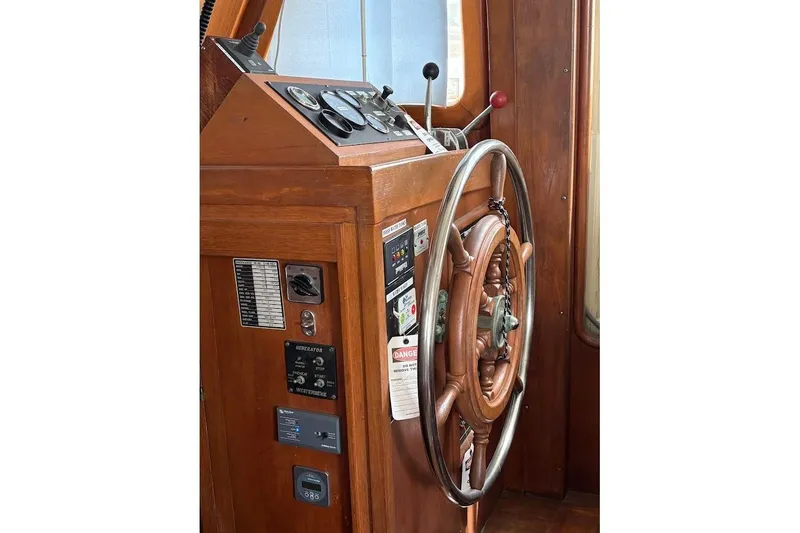 Slide: The Image of Wooden helm and controls of a 1987 Albin 36 Trawler boat. - 13
