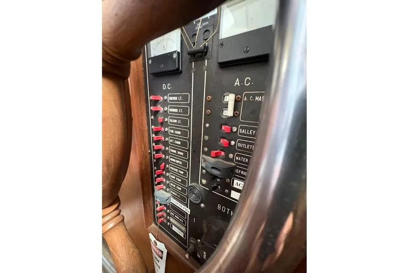 Slide: The Image of Electrical panel of a 1987 Albin 36 Trawler, featuring DC and AC switches. - 14