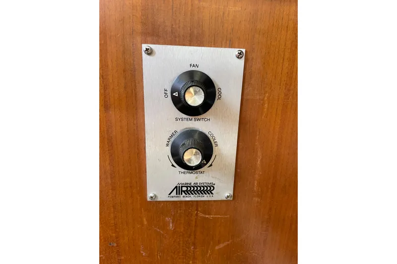 Slide: The Image of Control panel on 1987 Albin 36 Trawler, featuring system switch and thermostat. - 17