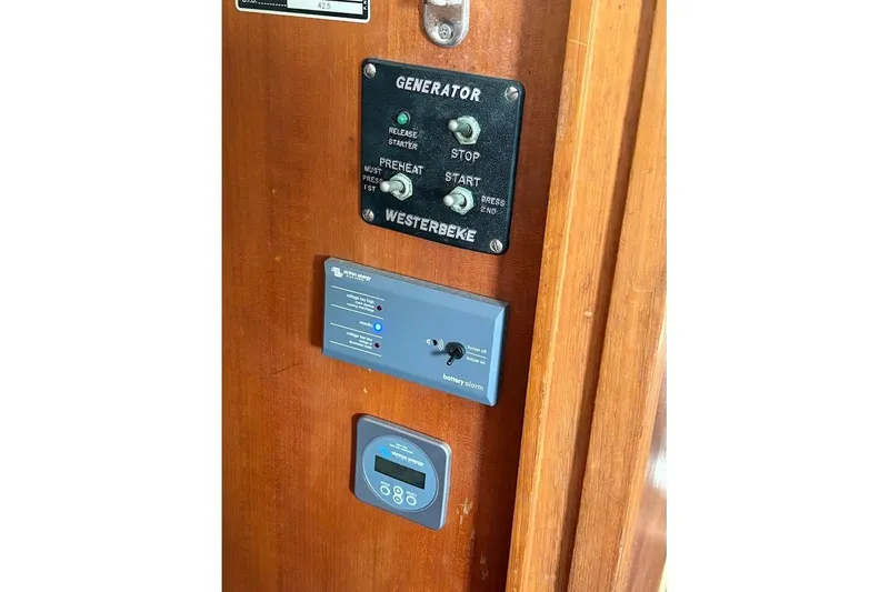 Slide: The Image of Control panel on 1987 Albin 36 Trawler with generator and battery indicators. - 18
