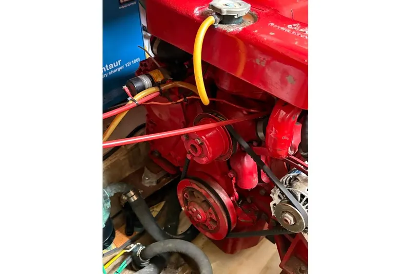 Slide: The Image of Engine compartment of a 1987 Albin 36 Trawler with red components and wiring. - 20