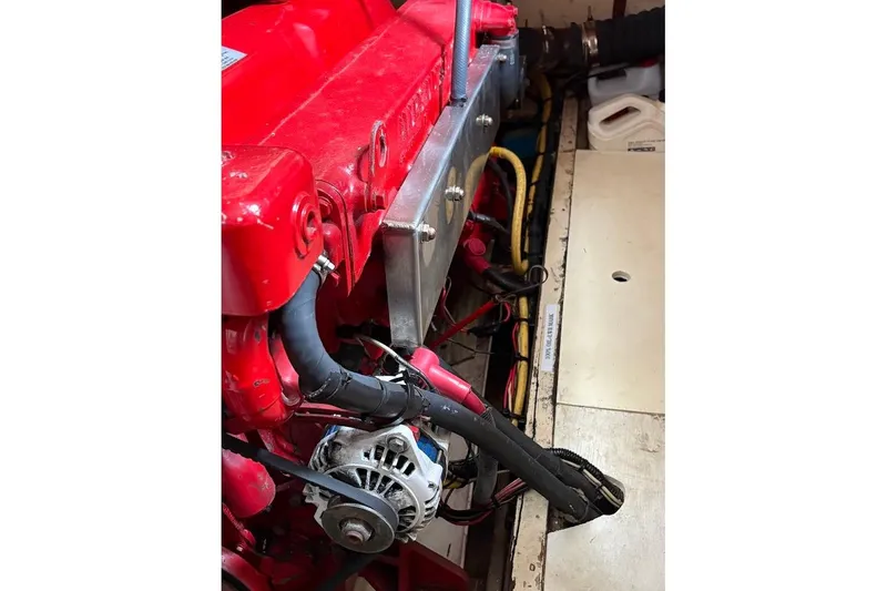 Slide: The Image of Engine compartment of a 1987 Albin 36 Trawler, featuring a red engine and wiring. - 21
