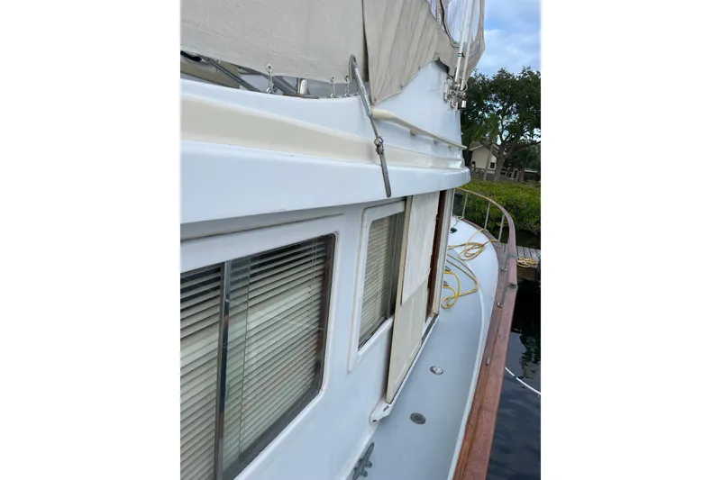 Slide: The Image of 1987 Albin 36 Trawler side deck view with windows and railing. - 27