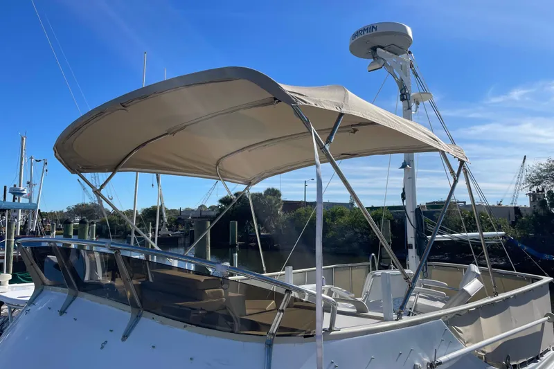 Slide: The Image of 1987 Albin 36 Trawler with canopy, docked under clear blue sky. - 31