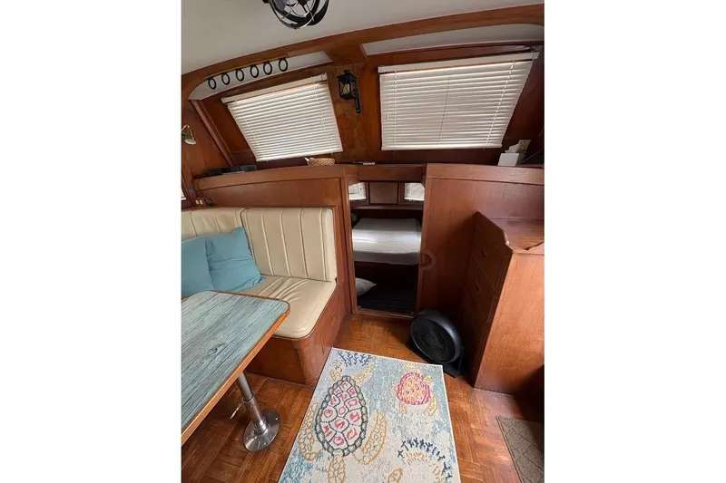 Slide: The Image of Interior of 1987 Albin 36 Trawler with cozy seating and wooden accents. - 4