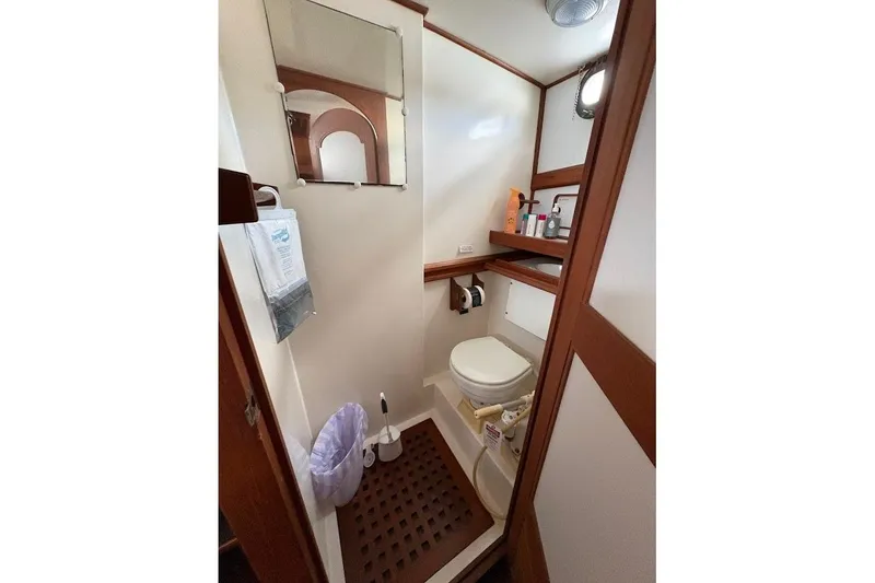 Slide: The Image of Bathroom interior of 1987 Albin 36 Trawler with wooden accents and essential amenities. - 8