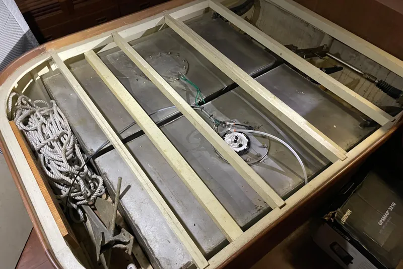 Slide: The Image of Engine compartment of a 1987 Albin 36 Trawler with visible fuel tanks and ropes. - 9