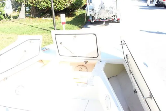 Slide: The Image of Open storage compartments on a 2017 Mako 21 LTS boat. - 15