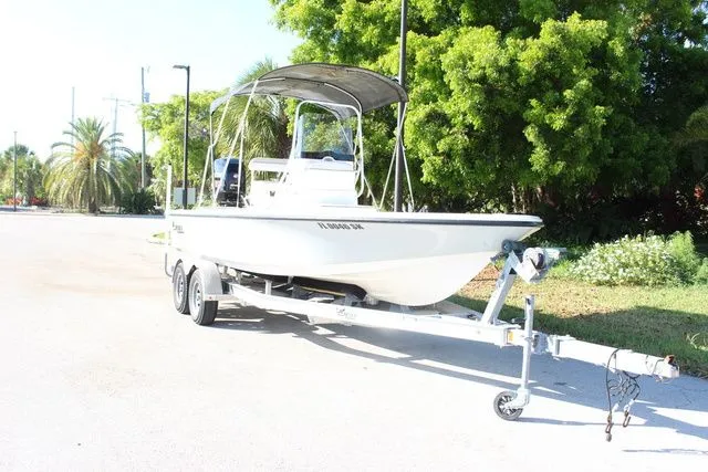 Slide: The Image of 2017 Mako 21 LTS boat on trailer, sunny day, green trees in background. - 3