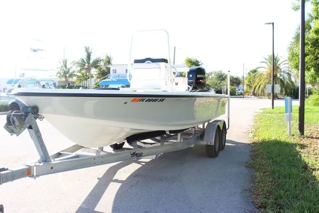 Slide: The Image of 2017 Mako 21 LTS boat on trailer, sunny day, palm trees in background. - 7