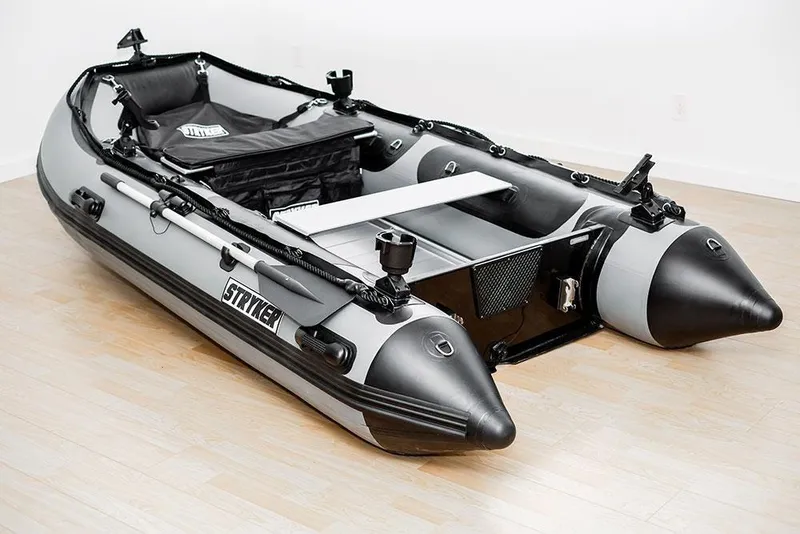 The Image of 2026 Stryker LX 360 inflatable boat with sleek design on wooden floor. - 1