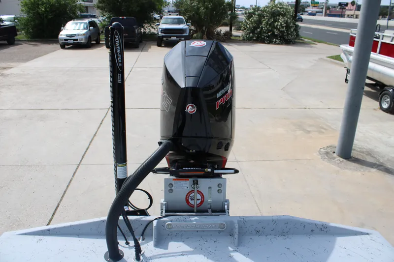 Slide: The Image of 2026 Freedom Boats 21' Commander with Mercury Pro XS engine, parked outdoors. - 22