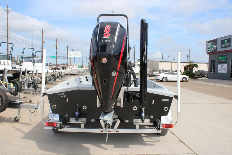 Slide: The Image of 2026 Freedom Boats 21' Commander with powerful V8 engine, parked outdoors. - 3