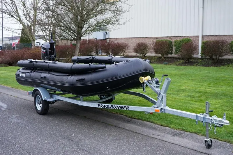 The Image of 2025 Stryker Tunnel JET PRO 470 inflatable boat on trailer, parked outdoors. - 1