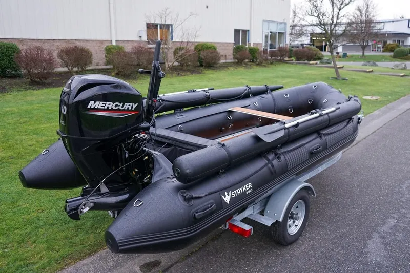 Slide: The Image of 2025 Stryker Tunnel JET PRO 470 inflatable boat with Mercury engine on trailer. - 4