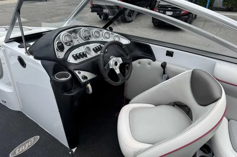 Slide: The Image of Interior of a 2006 Tigé 22Ve boat with steering wheel and dashboard controls. - 12