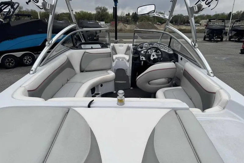 Slide: The Image of 2006 Tigé 22Ve boat interior with gray seating and modern dashboard. - 13