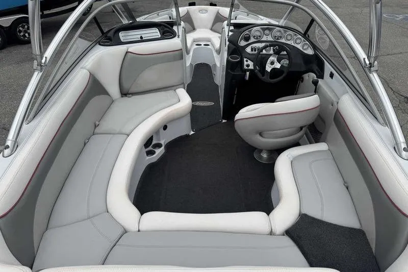 Slide: The Image of Interior of a 2006 Tigé 22Ve boat with plush seating and modern dashboard. - 16