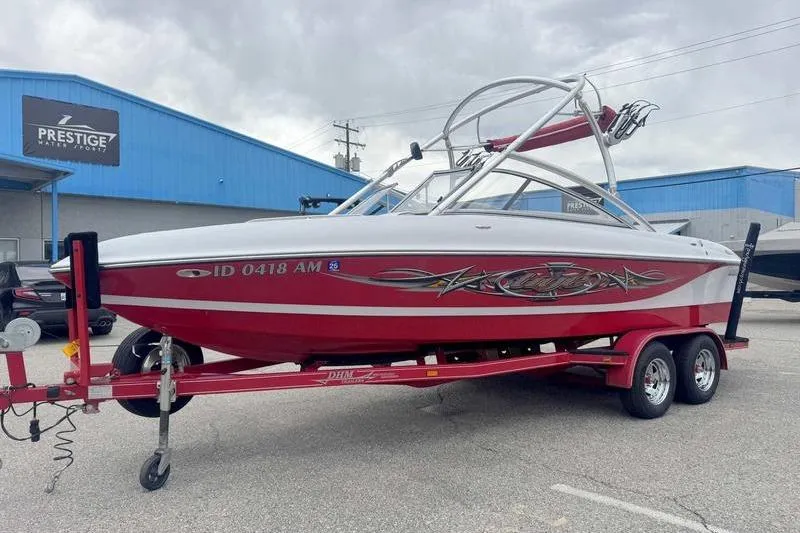 Slide: The Image of 2006 Tigé 22Ve boat on red trailer, parked outside Prestige Water Sports building. - 3