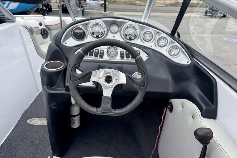 Slide: The Image of 2006 Tigé 22Ve boat dashboard with steering wheel and gauges. - 6