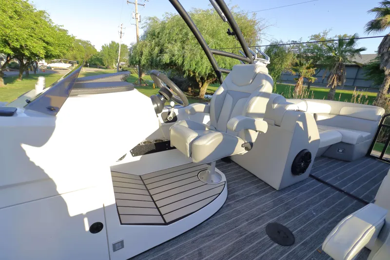 Slide: The Image of 2021 Montara Surf Boss 2.0 25 boat interior with modern seating and steering wheel. - 12