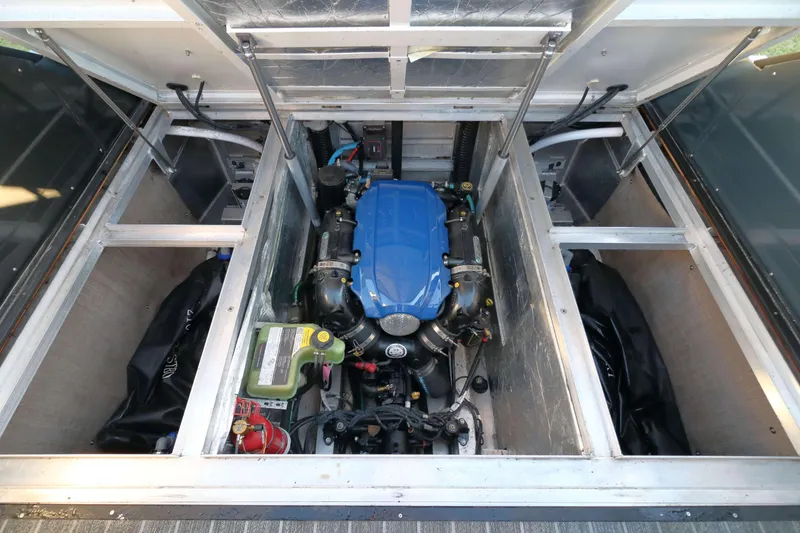 Slide: The Image of Engine compartment of 2021 Montara Surf Boss 2.0 25 with blue engine cover. - 15