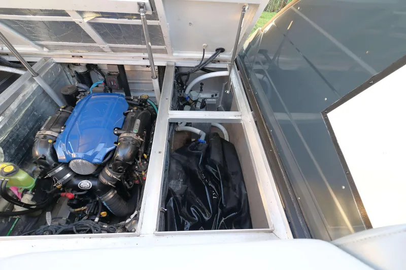 Slide: The Image of Engine compartment of 2021 Montara Surf Boss 2.0 25 with blue engine cover. - 17