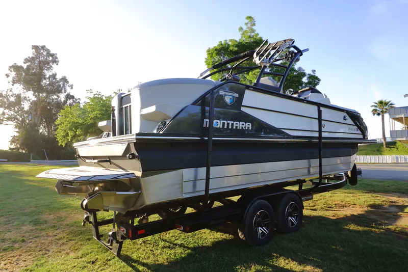 Slide: The Image of 2021 Montara Surf Boss 2.0 25 boat on trailer, parked on grass. - 4