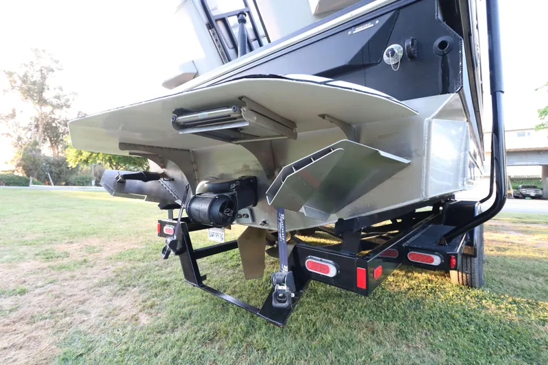 Slide: The Image of 2021 Montara Surf Boss 2.0 25 boat on trailer, rear view showing propeller and hull design. - 5