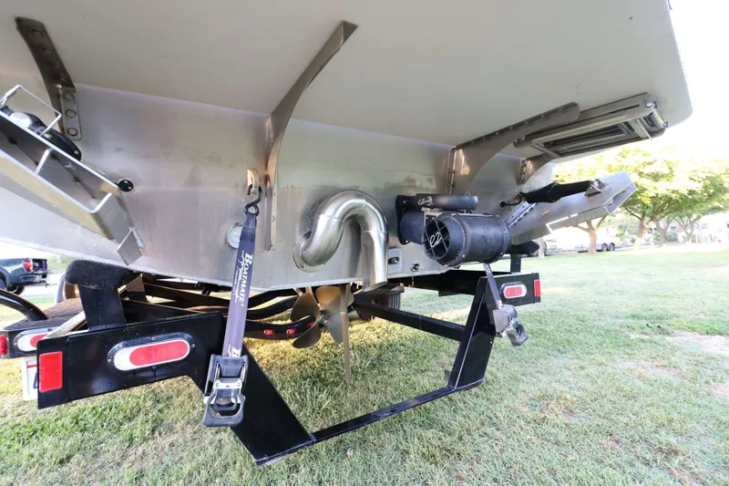 Slide: The Image of Rear view of 2021 Montara Surf Boss 2.0 25 boat on trailer, showing propeller and exhaust system. - 6