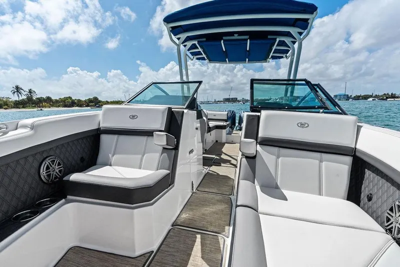 Slide: The Image of 2022 Cobalt R8 Outboard boat interior with luxurious seating and scenic water view. - 2