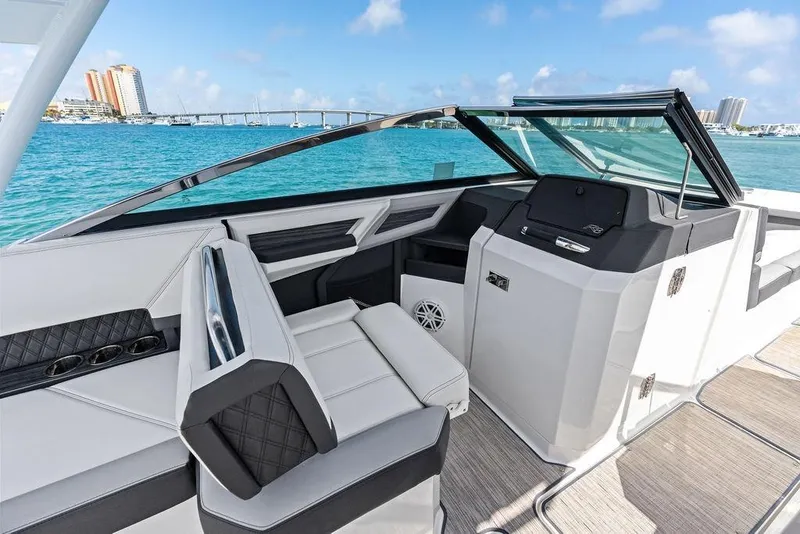 Slide: The Image of 2022 Cobalt R8 Outboard boat interior with sleek design and waterfront view. - 22