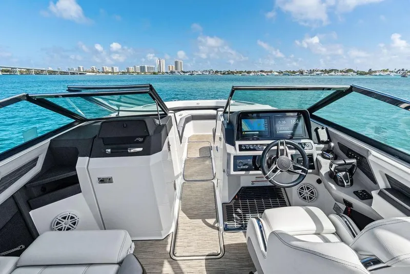 Slide: The Image of 2022 Cobalt R8 Outboard boat interior with modern dashboard, steering wheel, and ocean view. - 3