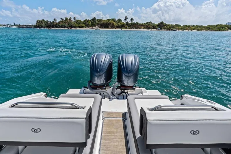 Slide: The Image of 2022 Cobalt R8 Outboard boat on water, tropical island in background. - 30