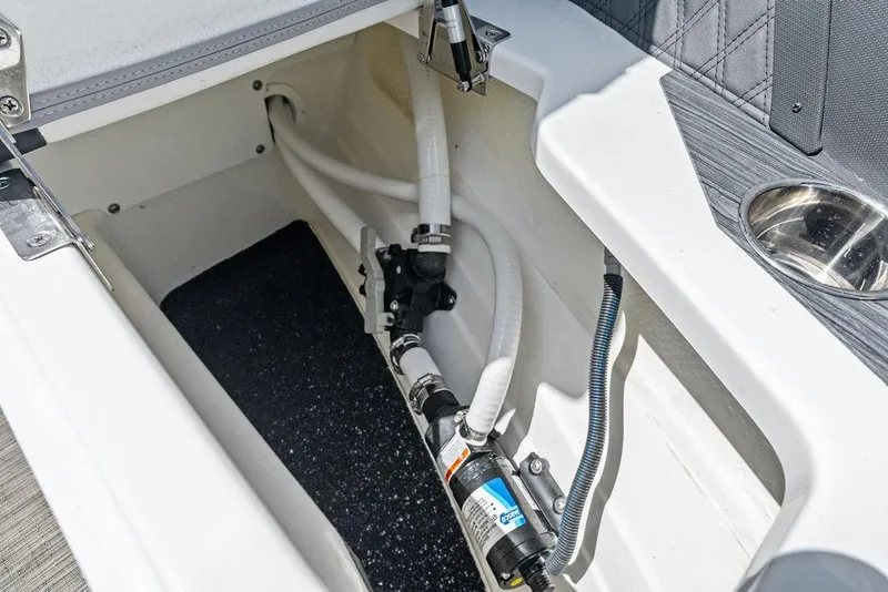 Slide: The Image of 2022 Cobalt R8 Outboard boat storage compartment with visible plumbing and wiring. - 37