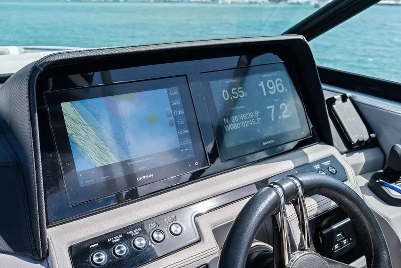Slide: The Image of 2022 Cobalt R8 Outboard dashboard with Garmin navigation screens on a sunny day. - 4